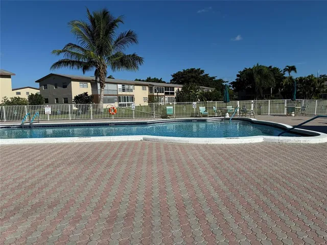 a view of multiple houses with a swimming pool