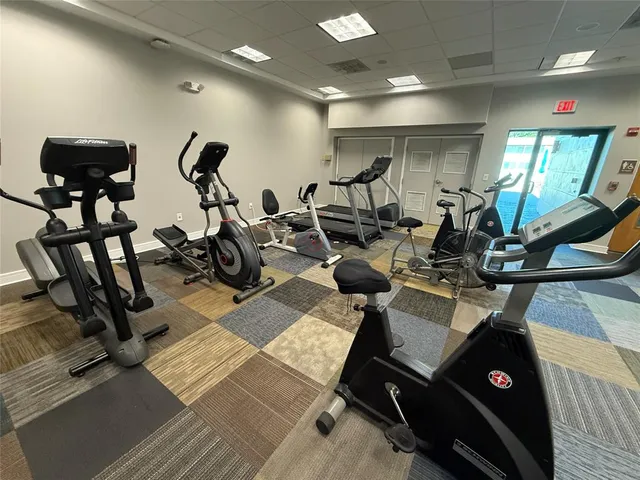 a room with pool table and wooden floor