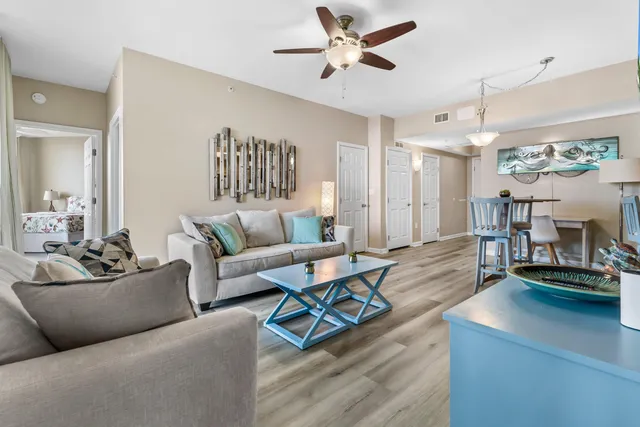 a living room with furniture and a chandelier