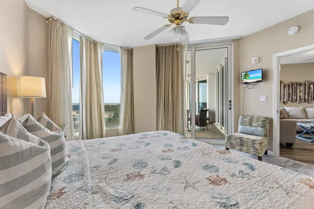 a bedroom with a bed and a chandelier