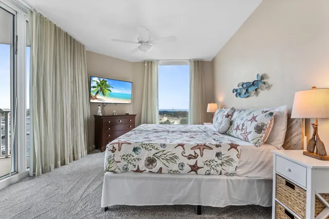 a bedroom with a bed and a chandelier