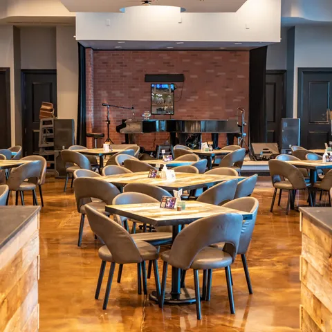 a living room with stainless steel appliances kitchen island granite countertop swimming pool and a large window