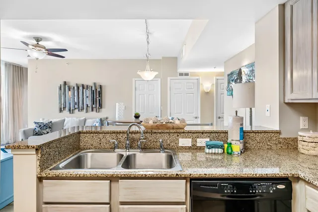 a kitchen with granite countertop a sink stainless steel appliances a counter space and cabinets