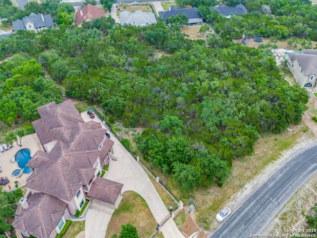 an aerial view of a house with a yard