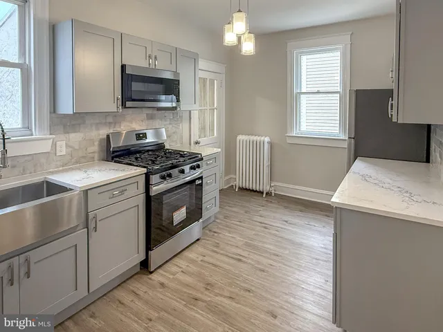 a kitchen with stainless steel appliances granite countertop a stove and a sink