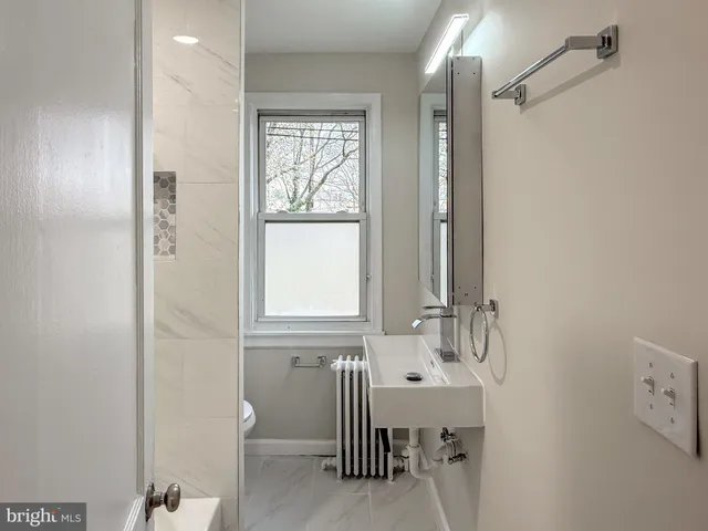 a bathroom with a bathtub sink and toilet