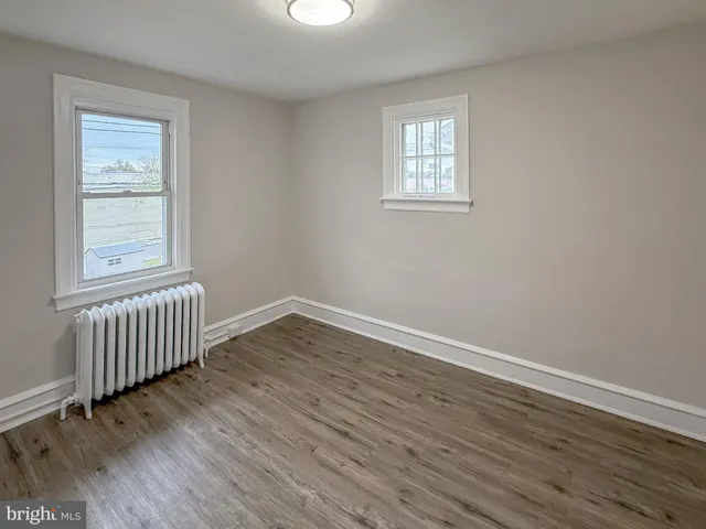 a view of a room with wooden floor and window