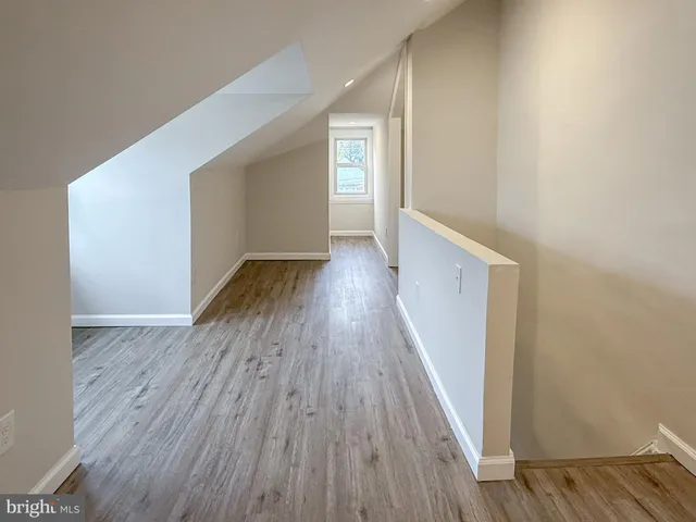 a view of hallway with wooden floor