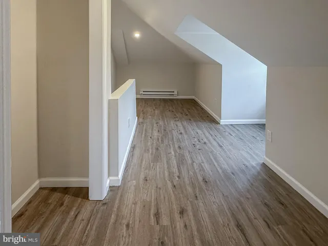 a view of an empty room with a staircase