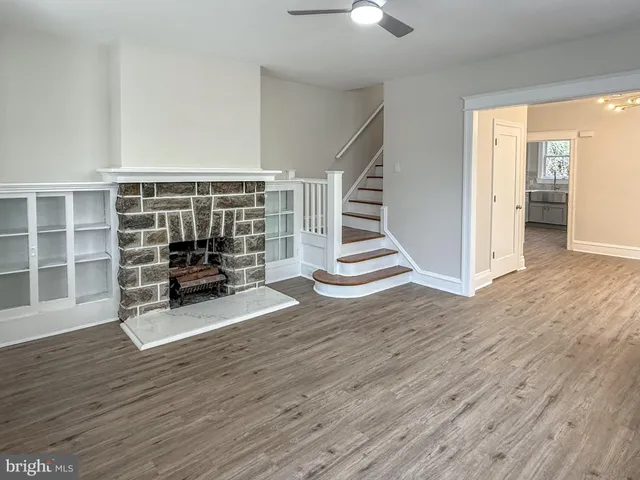a view of wooden floor and windows in a room