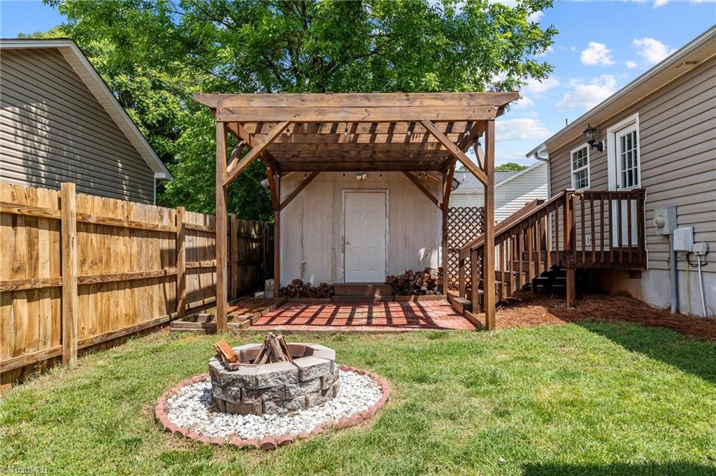 800 Linens Street Graham, NC 27253 - Photo 31 of 41 Backyard fire pit and pergola