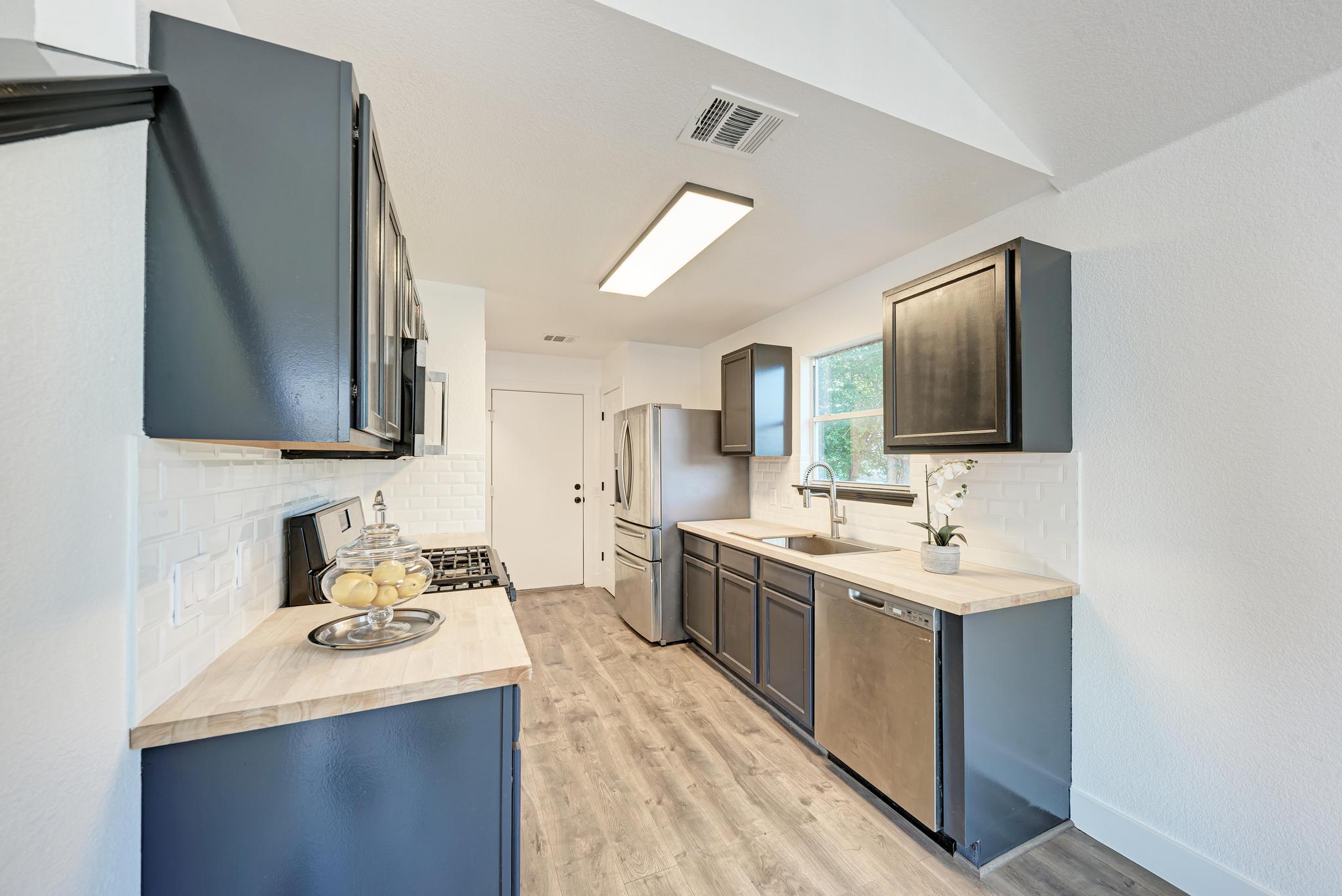 18108 Belfry Pass Manor, TX 78653 - Photo 3 of 40 a bathroom with a sink double vanity granite and a mirror