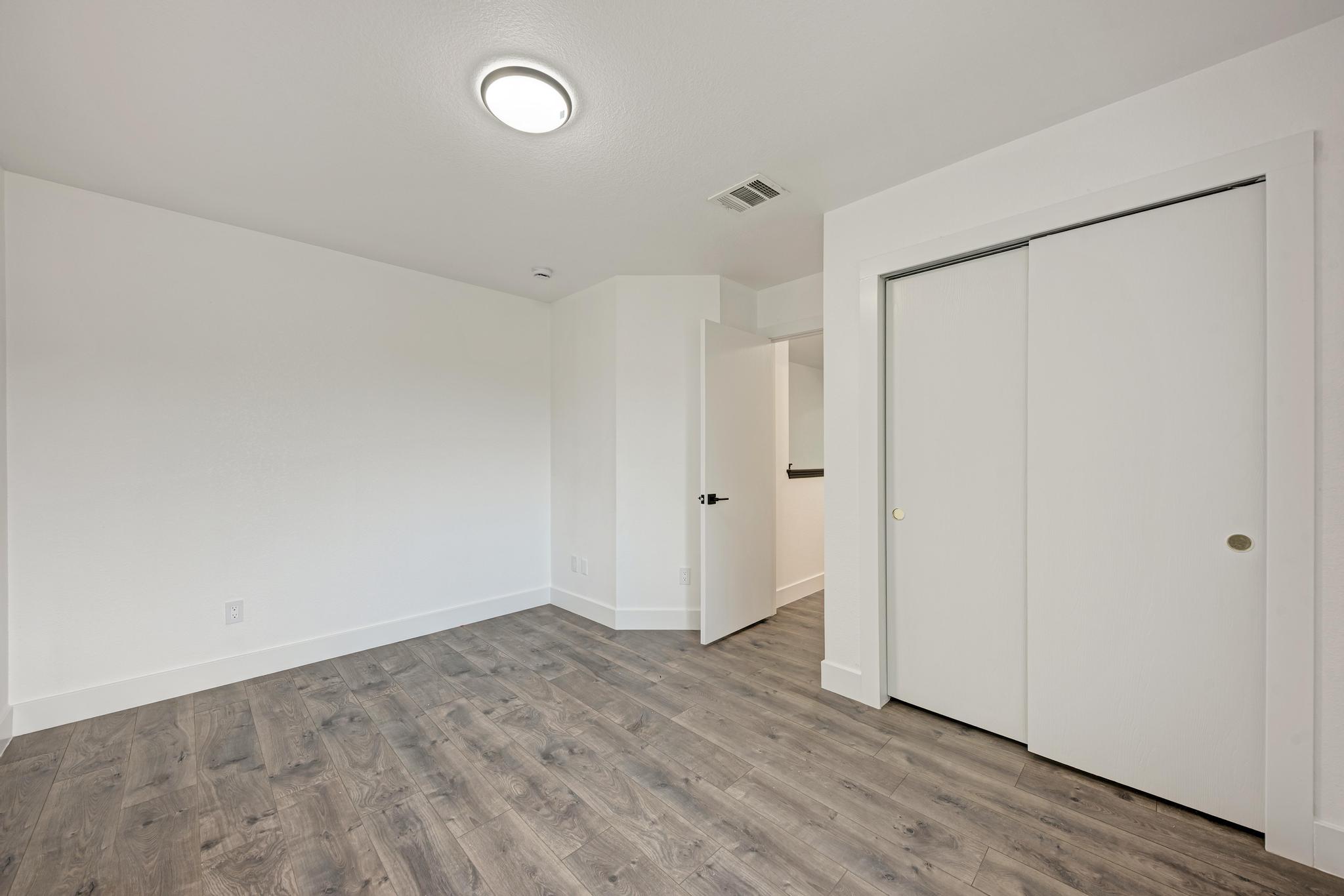 18108 Belfry Pass Manor, TX 78653 - Photo 33 of 40 a view of an empty room with wooden floor and closet