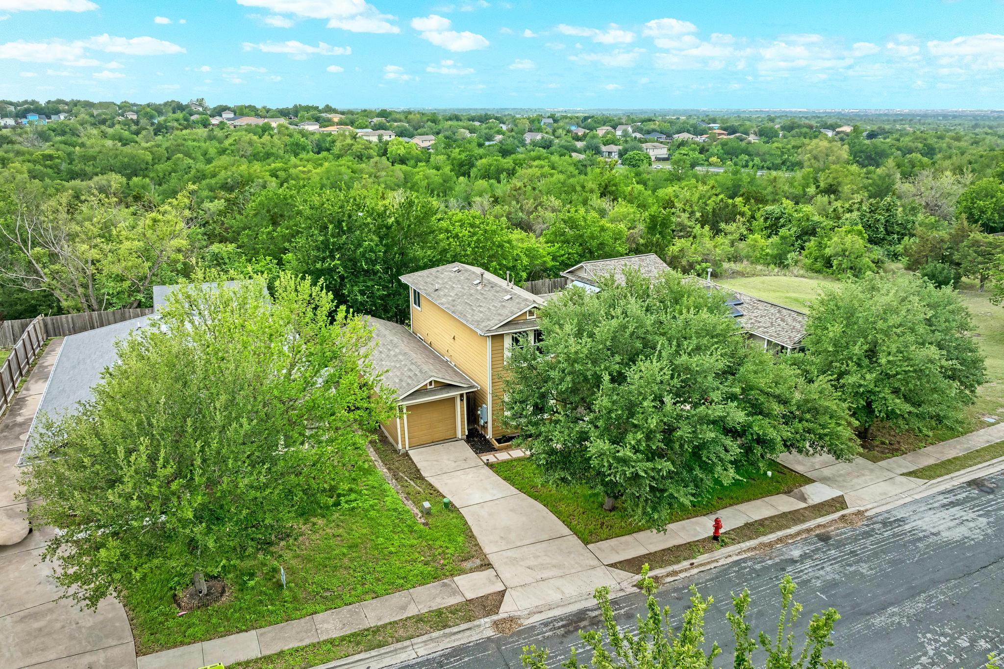 18108 Belfry Pass Manor, TX 78653 - Photo 7 of 40 a view of a garden with a lake