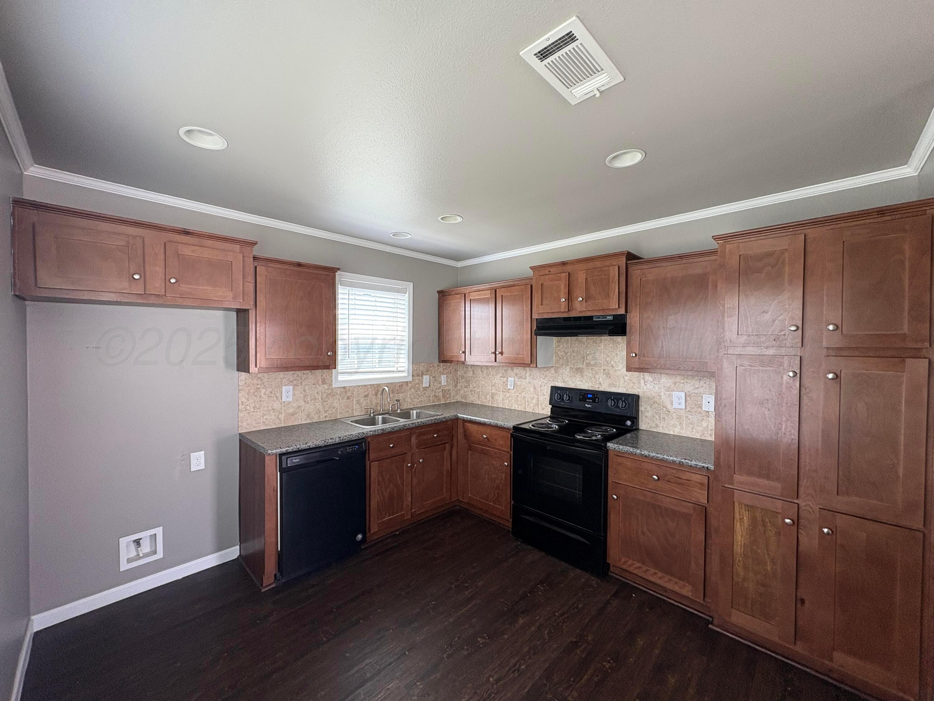 3501 Southeast 21st Avenue Amarillo, TX 79103 - Photo 4 of 11 a kitchen with stainless steel appliances granite countertop a refrigerator and a stove top oven