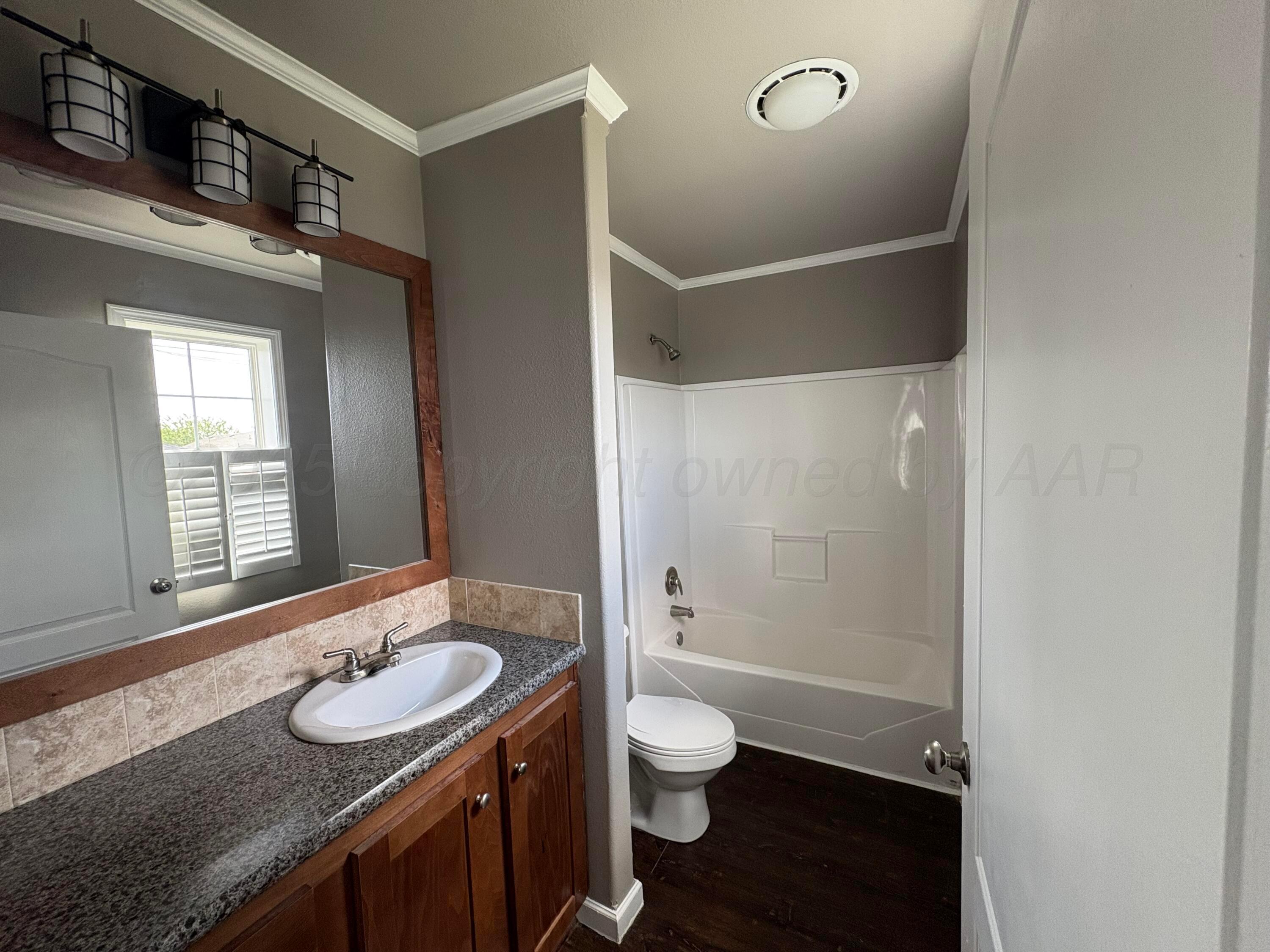 3501 Southeast 21st Avenue Amarillo, TX 79103 - Photo 10 of 11 a bathroom with a sink a toilet and shower
