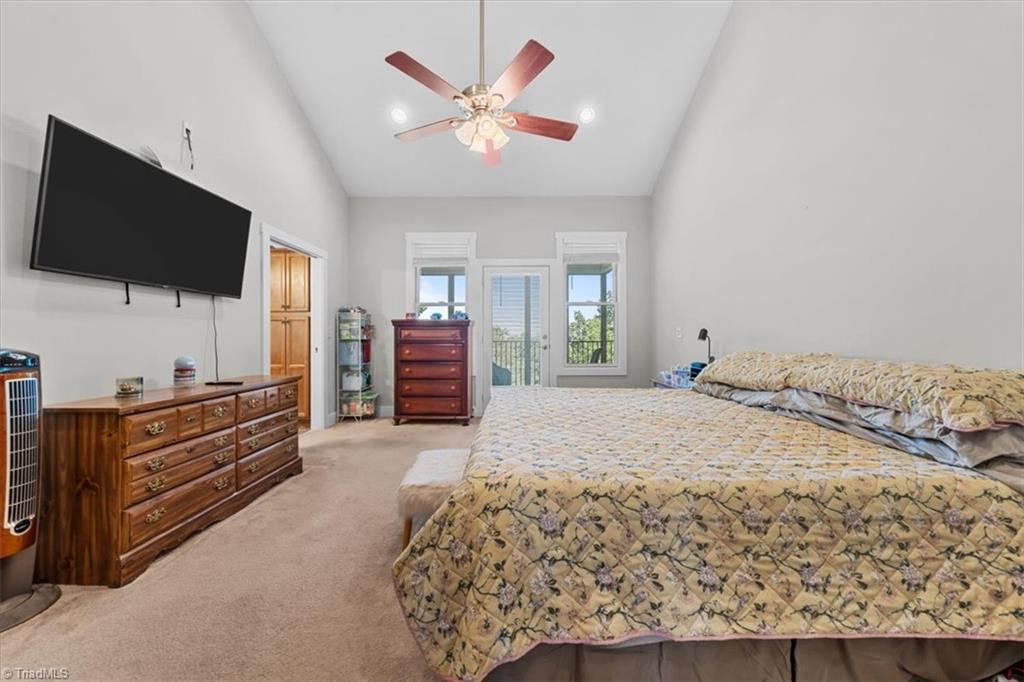 2207 Sierra Trace Road Denton, NC 27239 - Photo 21 of 49 Spacious primary suite featuring vaulted ceilings and private outdoor access