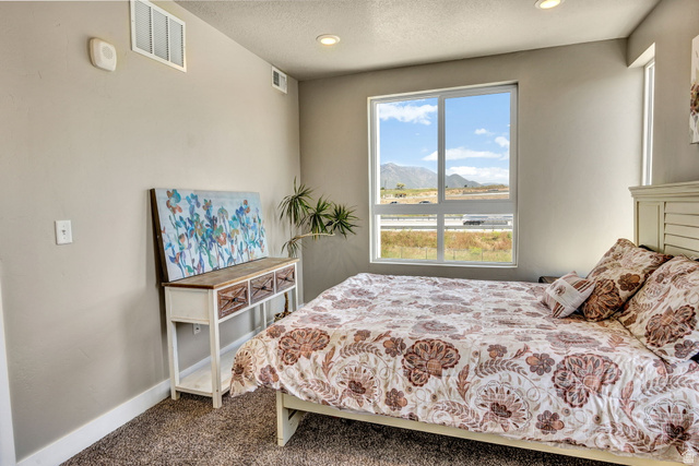 2101 North Main Street, Unit 306 Sunset, UT 84015 - Photo 16 of 22 Spacious room featuring a large window, recessed lighting, and neutral-toned walls