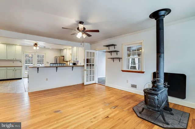 a view of a kitchen with cabinets appliances and wooden floor