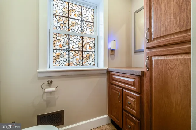 a bathroom with a sink a mirror and a window