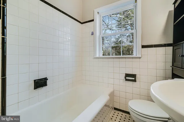 a bathroom with a bathtub and toilet