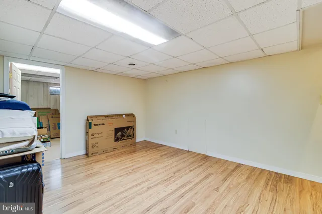 a room with a wooden floor and a sink