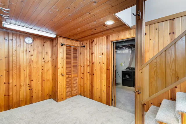 a view of hallway with wooden walls