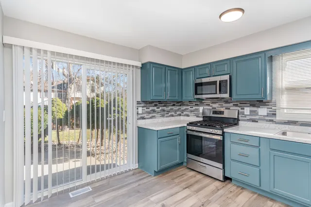 a kitchen with a sink stove and cabinets