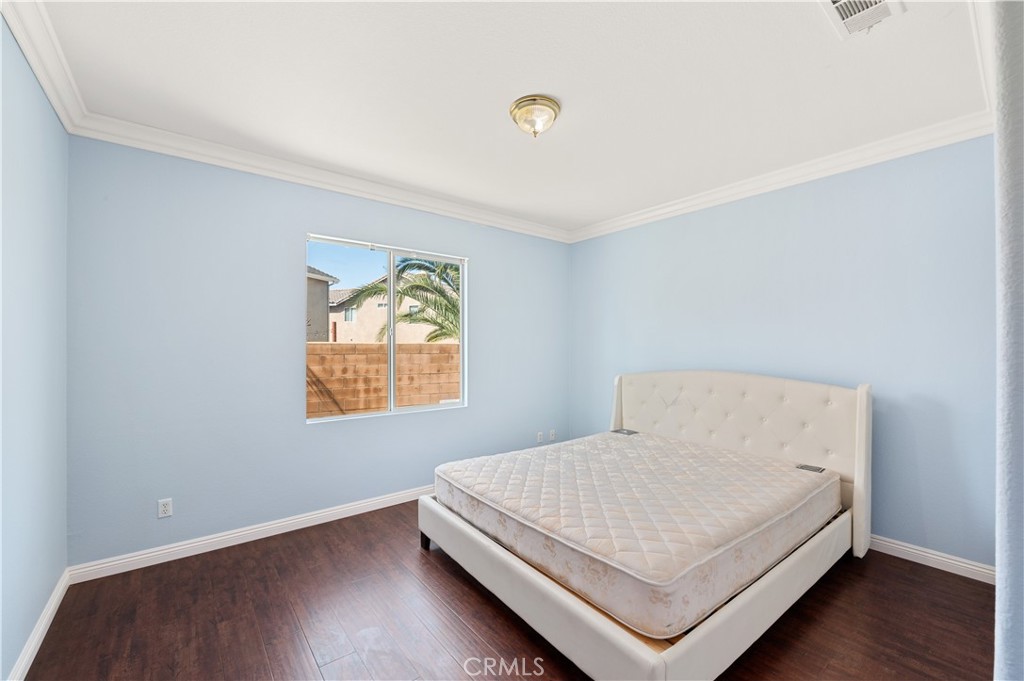 6469 Cattleman Drive Eastvale, CA 92880 - Photo 11 of 35 a bedroom with a bed and window