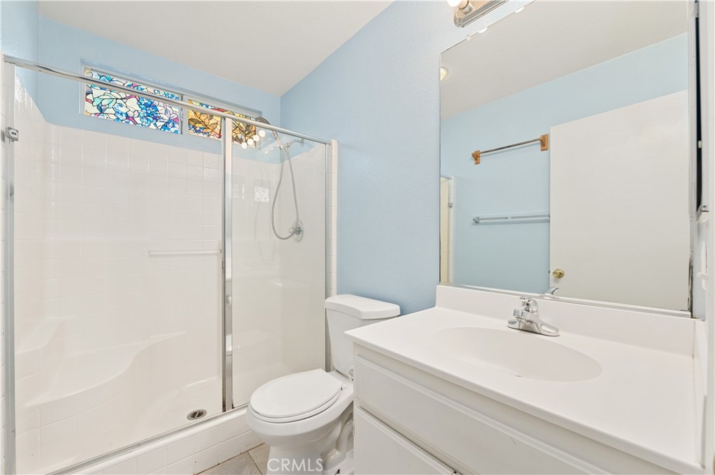 6469 Cattleman Drive Eastvale, CA 92880 - Photo 12 of 35 a bathroom with a sink a toilet and shower