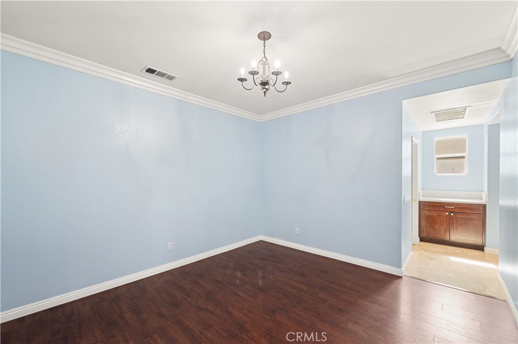 6469 Cattleman Drive Eastvale, CA 92880 - Photo 13 of 35 wooden floor in an empty room with a window