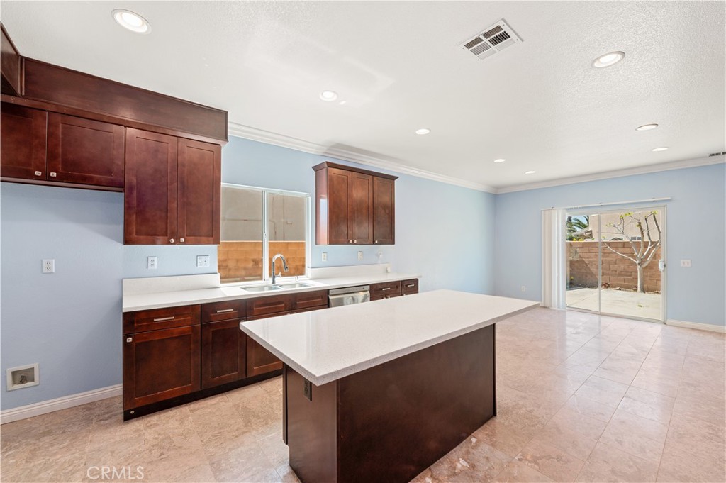 6469 Cattleman Drive Eastvale, CA 92880 - Photo 16 of 35 a kitchen with a sink cabinets and wooden floor