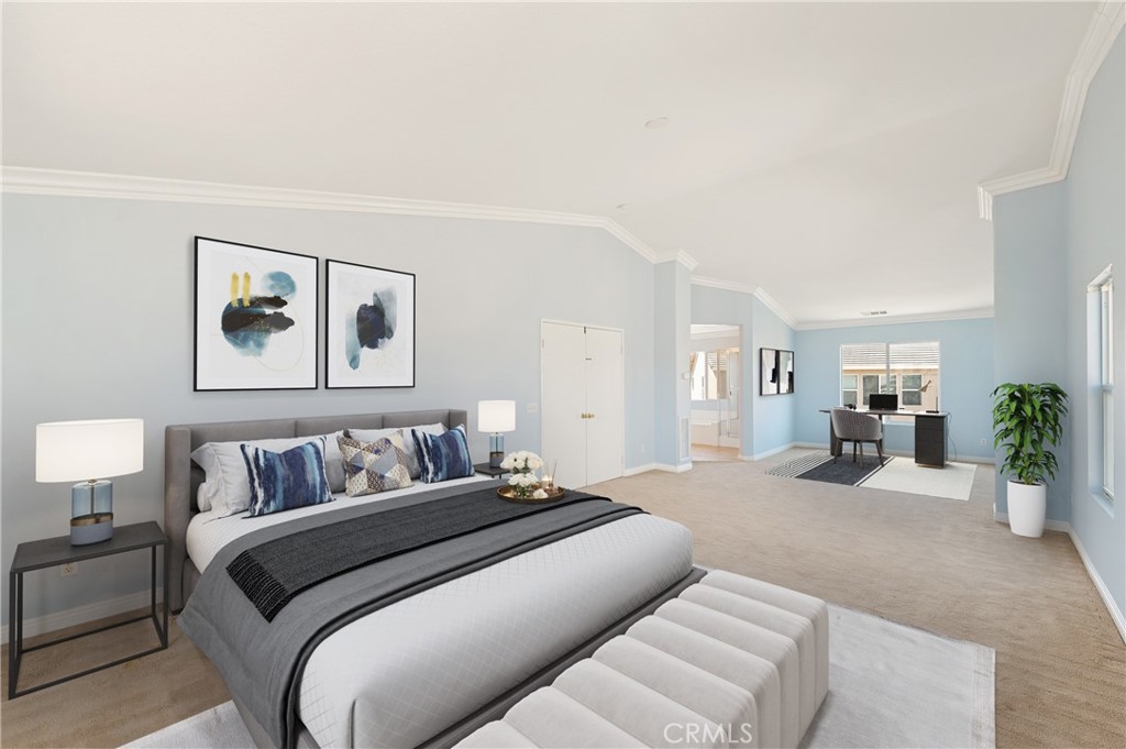 6469 Cattleman Drive Eastvale, CA 92880 - Photo 18 of 35 a bedroom with a large bed and paintings on the wall