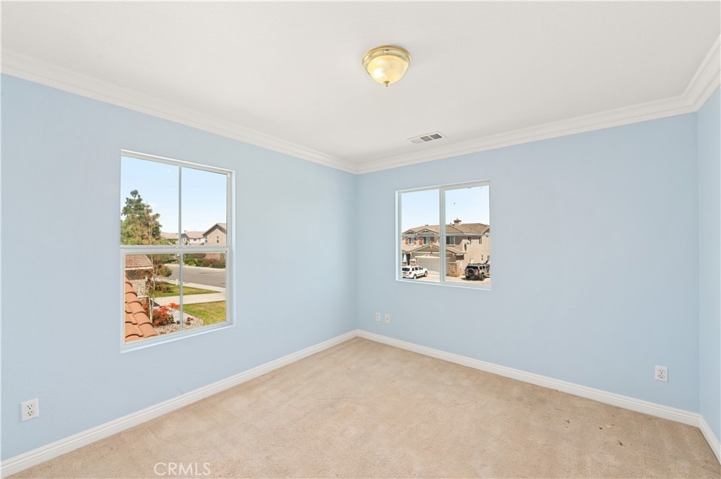 6469 Cattleman Drive Eastvale, CA 92880 - Photo 21 of 35 an empty room with windows and window