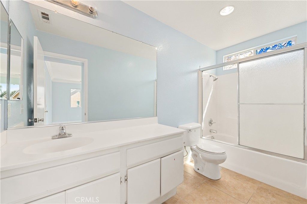 6469 Cattleman Drive Eastvale, CA 92880 - Photo 24 of 35 a bathroom with a sink toilet and shower