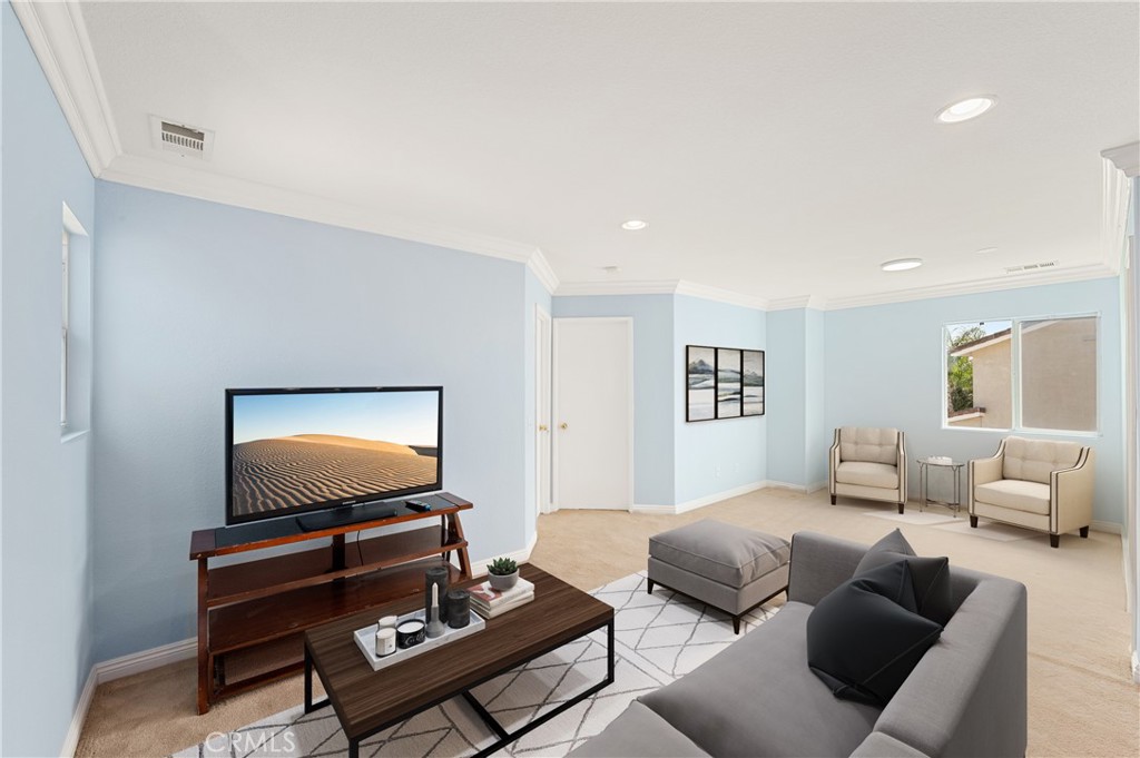 6469 Cattleman Drive Eastvale, CA 92880 - Photo 25 of 35 a living room with furniture and a flat screen tv
