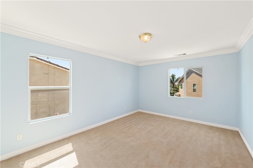 6469 Cattleman Drive Eastvale, CA 92880 - Photo 26 of 35 an empty room with windows