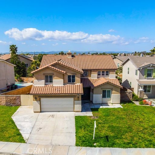 6469 Cattleman Drive Eastvale, CA 92880 - Photo 4 of 35 a front view of a house with a yard