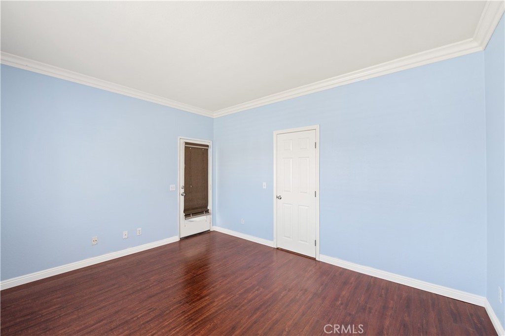 6469 Cattleman Drive Eastvale, CA 92880 - Photo 8 of 35 a view of an empty room with wooden floor