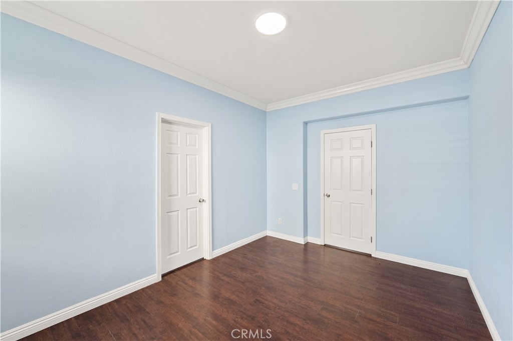 6469 Cattleman Drive Eastvale, CA 92880 - Photo 9 of 35 a view of an empty room with wooden floor and closet