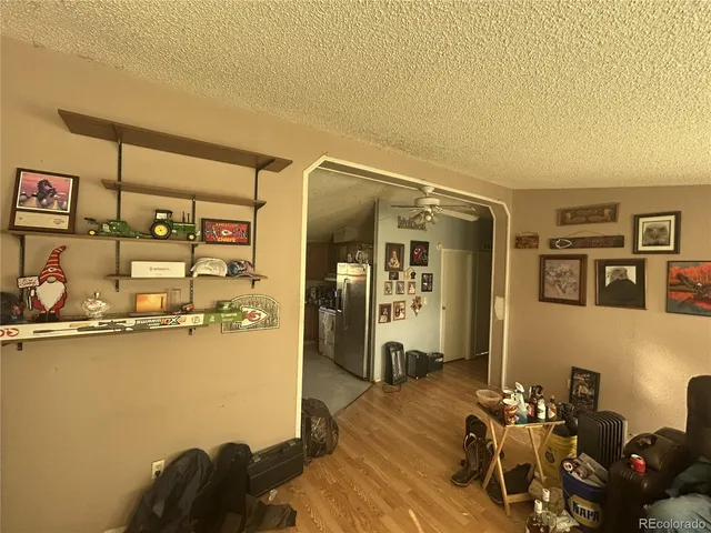 a bedroom with furniture and a wooden floor