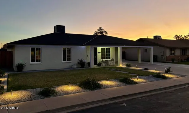 a front view of a house with garden