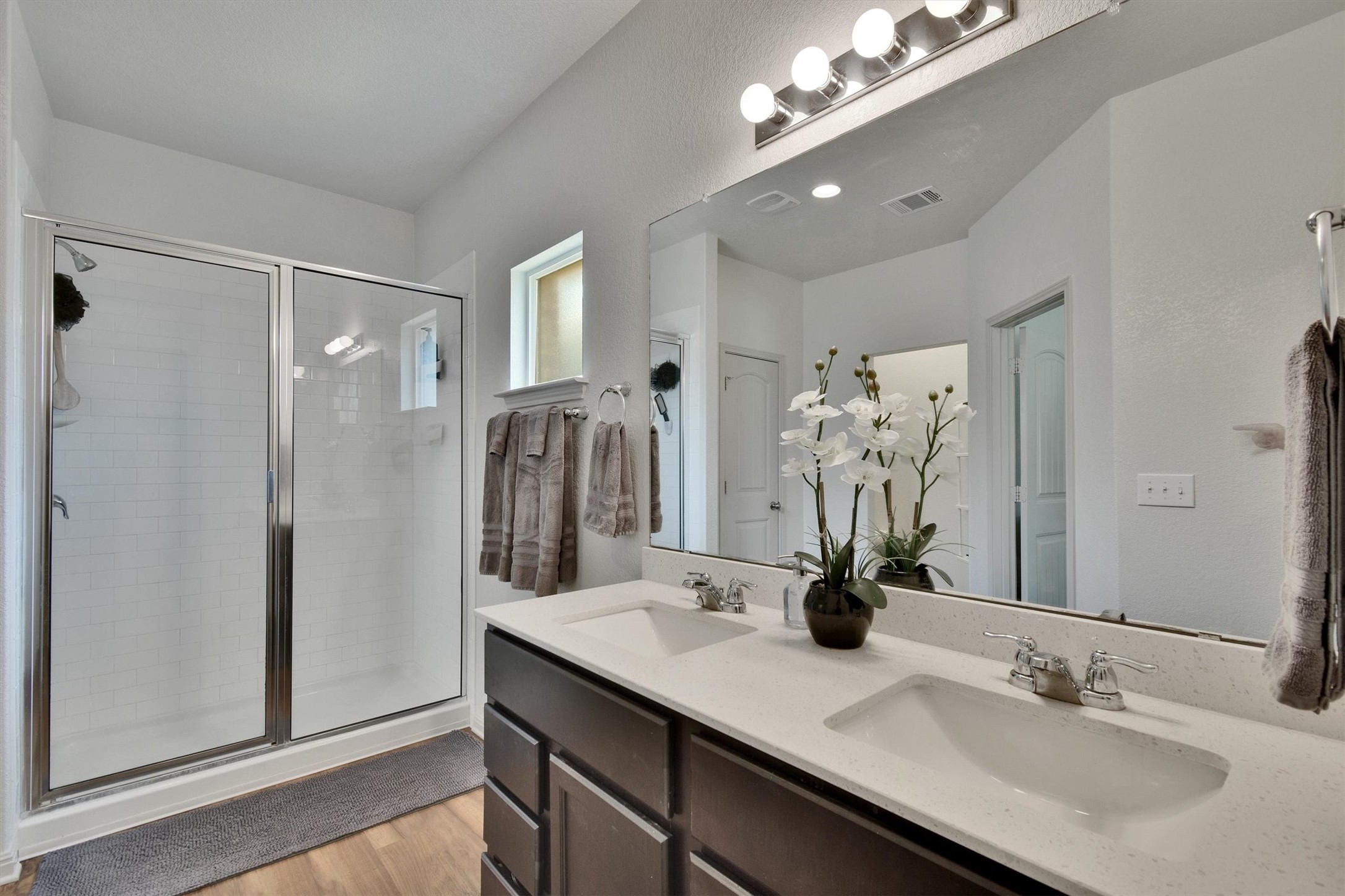 324 Shiner Lane Georgetown, TX 78626 - Photo 21 of 39 a bathroom with a double vanity sink a large mirror and shower