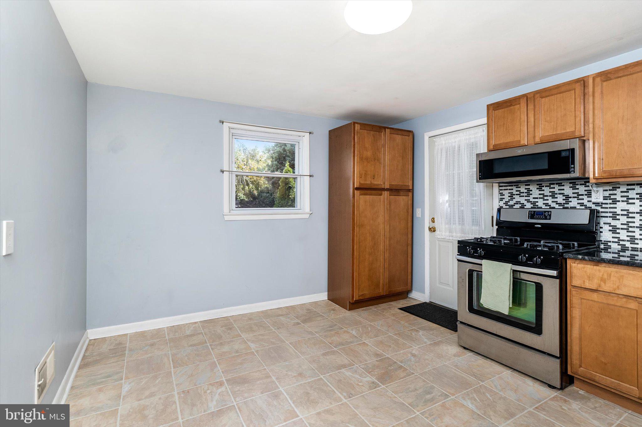 81 3rd Avenue Hamilton, NJ 08619 - Photo 6 of 26 a kitchen with stainless steel appliances granite countertop a stove a refrigerator and a sink