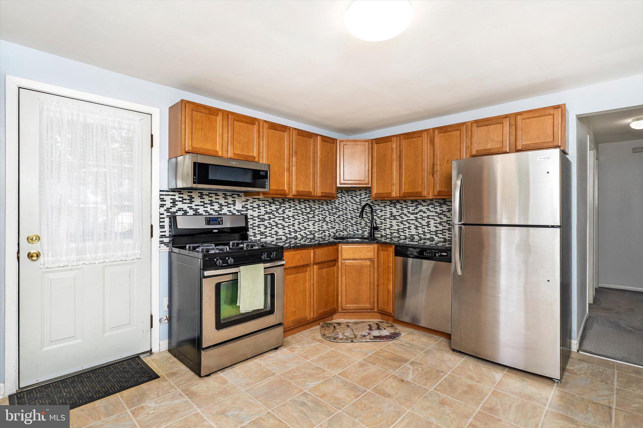 81 3rd Avenue Hamilton, NJ 08619 - Photo 8 of 26 a kitchen with granite countertop a refrigerator and a sink