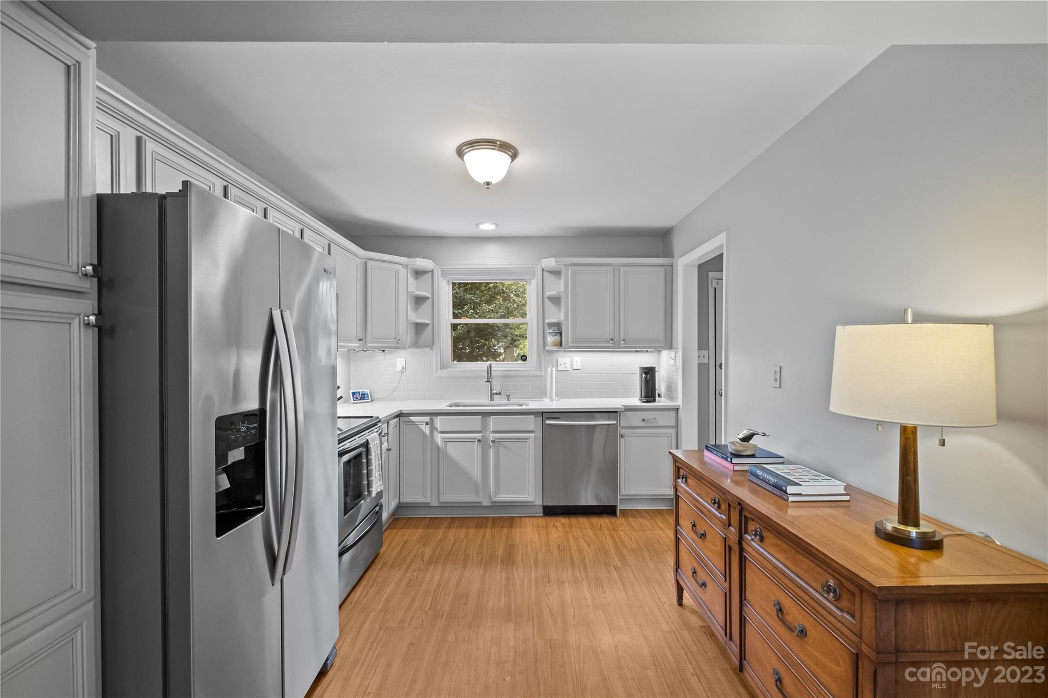 4014 Sulkirk Road Charlotte, NC 28210 - Photo 11 of 23 a kitchen with kitchen island a counter top space a sink stainless steel appliances and cabinets