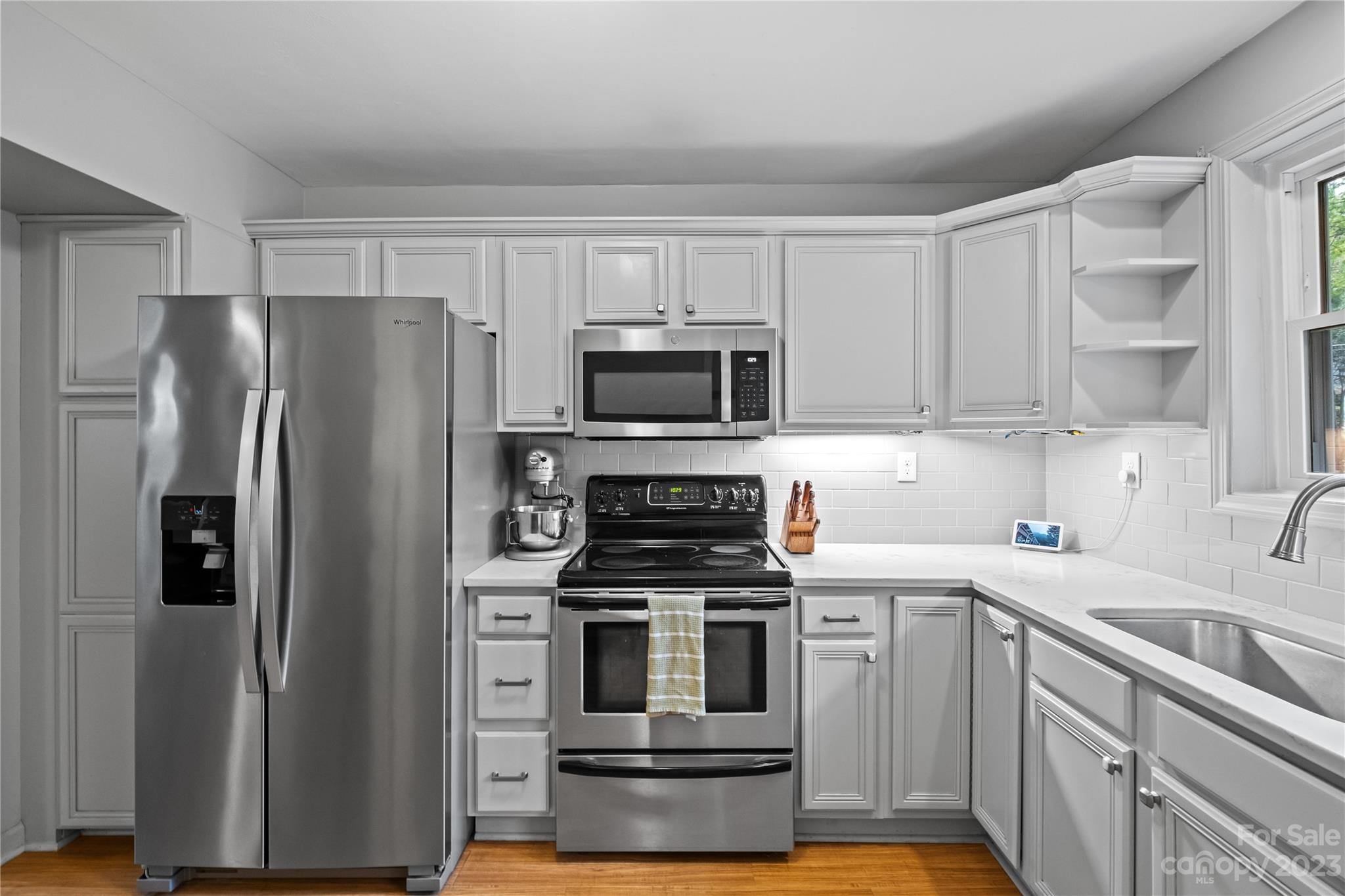 4014 Sulkirk Road Charlotte, NC 28210 - Photo 12 of 23 a kitchen with cabinets and stainless steel appliances