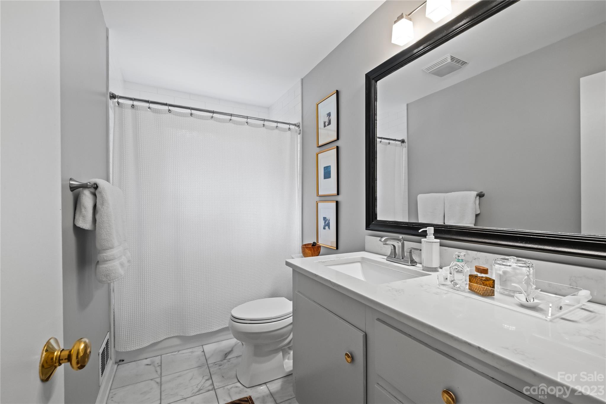 4014 Sulkirk Road Charlotte, NC 28210 - Photo 14 of 23 a bathroom with a sink a toilet and shower