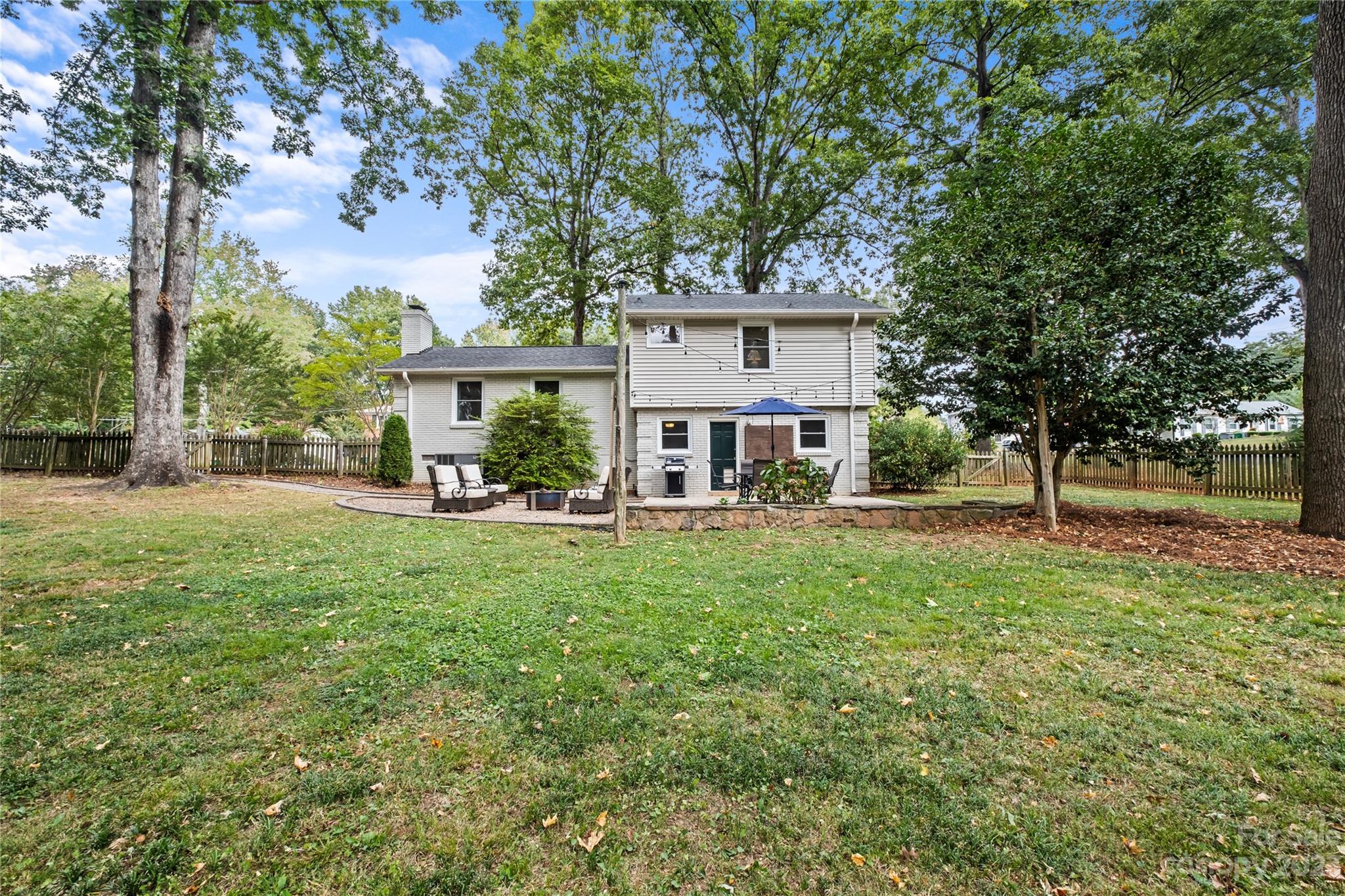4014 Sulkirk Road Charlotte, NC 28210 - Photo 22 of 23 a view of a house with backyard and a tree