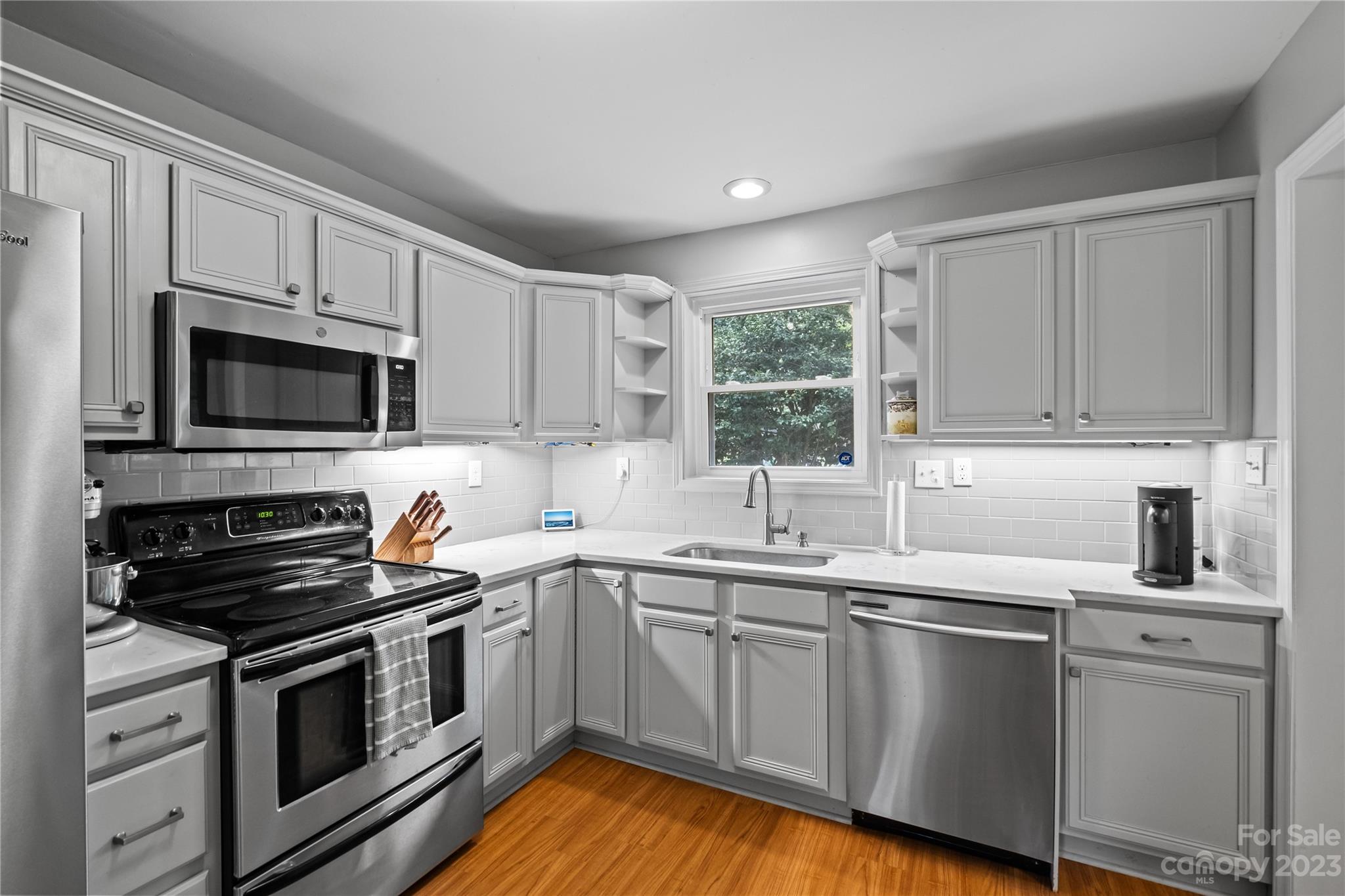 4014 Sulkirk Road Charlotte, NC 28210 - Photo 10 of 23 a kitchen with a sink stove and microwave